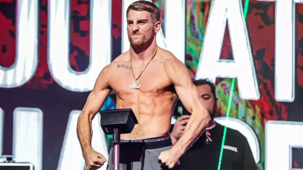 Fighter stepping on scale at weigh-in demonstrating accountability in losing weight