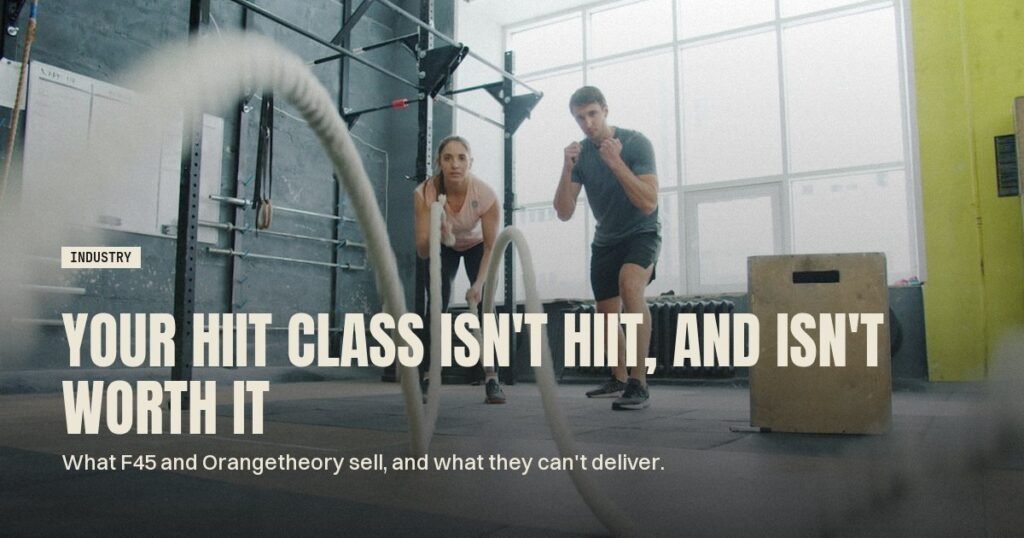 Two people swinging battle ropes in a high-intensity gym class