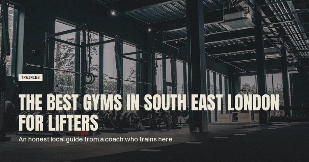 Dark industrial gym floor with squat racks, benches and stacked bumper plates