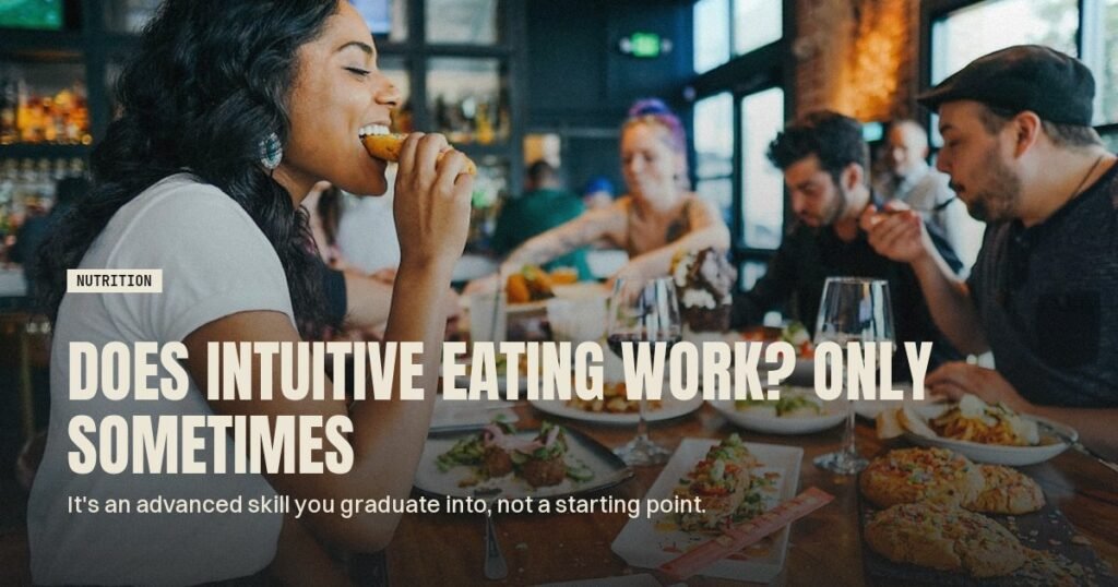 Woman eating a meal at a busy restaurant table with friends